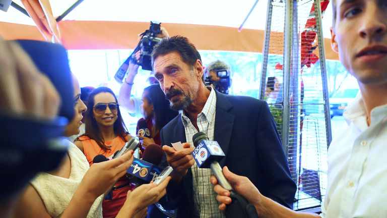 MIAMI BEACH, FL - DECEMBER 13:  John McAfee talks to the media outside Beacon Hotel where he is staying after arriving last night from Guatemala on December 13, 2012 in Miami Beach, Florida. McAfee is a "person of interest" in the fatal shooting of his neighbor in Belize and turned up in Guatemala after a month on the run in Belize.  (Photo by Joe Raedle/Getty Images)