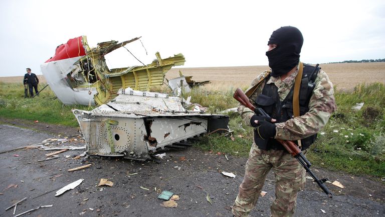 A pro-Russian separatist stands at the crash site of Malaysia Airlines flight MH17, near the village of Hrabove (Grabovo) in Donetsk region, Ukraine