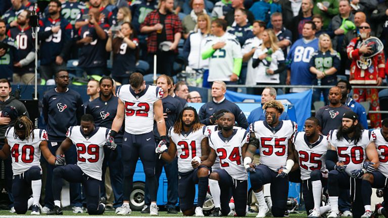 Members of the Houston Texas kneel before their games at the Seattle Seahawks
