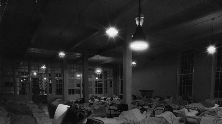 A night nurse sits in the ward of a mental hospital in 1956
