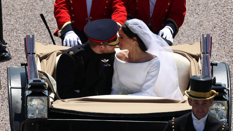 Prince Harry and Meghan Markle kiss in an Ascot Landau 