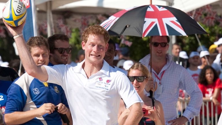 Prince Harry shows off his rugby skills as Paul watches on