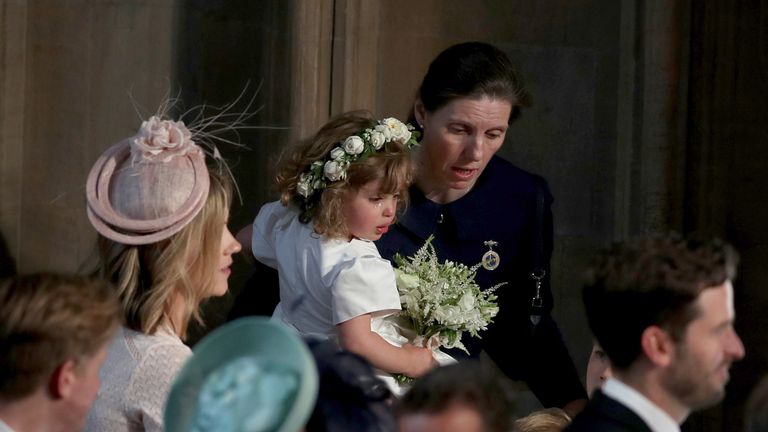 WINDSOR, UNITED KINGDOM - MAY 19: A crying flower girl is comforted inside the entrance to the chapel before the wedding of Prince Harry to Meghan Markle in St George&#39;s Chapel at Windsor Castle on May 19, 2018 in Windsor, England. (Photo by Owen Humphreys - WPA Pool/Getty Images)