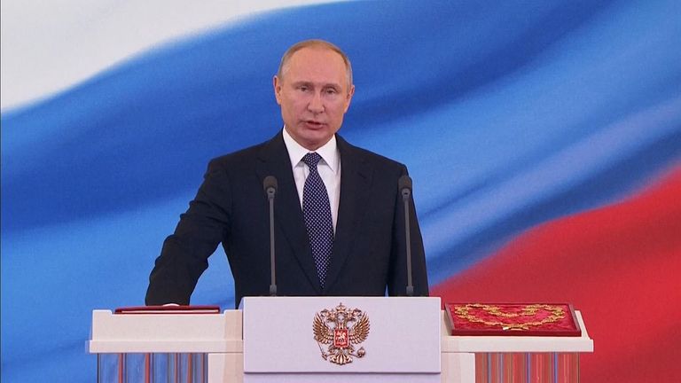 Vladimir Putin is sworn in at the lectern