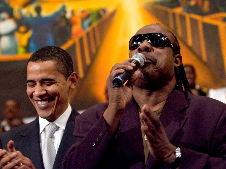 LOS ANGELES - APRIL 29: Democratic presidential hopeful Senator Barack Obama (D-IL) (L) is joined by a singing Stevie Wonder during a service commemorating the Los Angeles riots at the First AME Church April 29, 2007 in Los Angeles, California. The Los Angeles riots, which started 15 years ago on April 29, 1992, lasted three days and resulted in 53 deaths. (Photo by Ann Johansson/Getty Images) *** Local Caption *** Barack Obama;Stevie Wonder