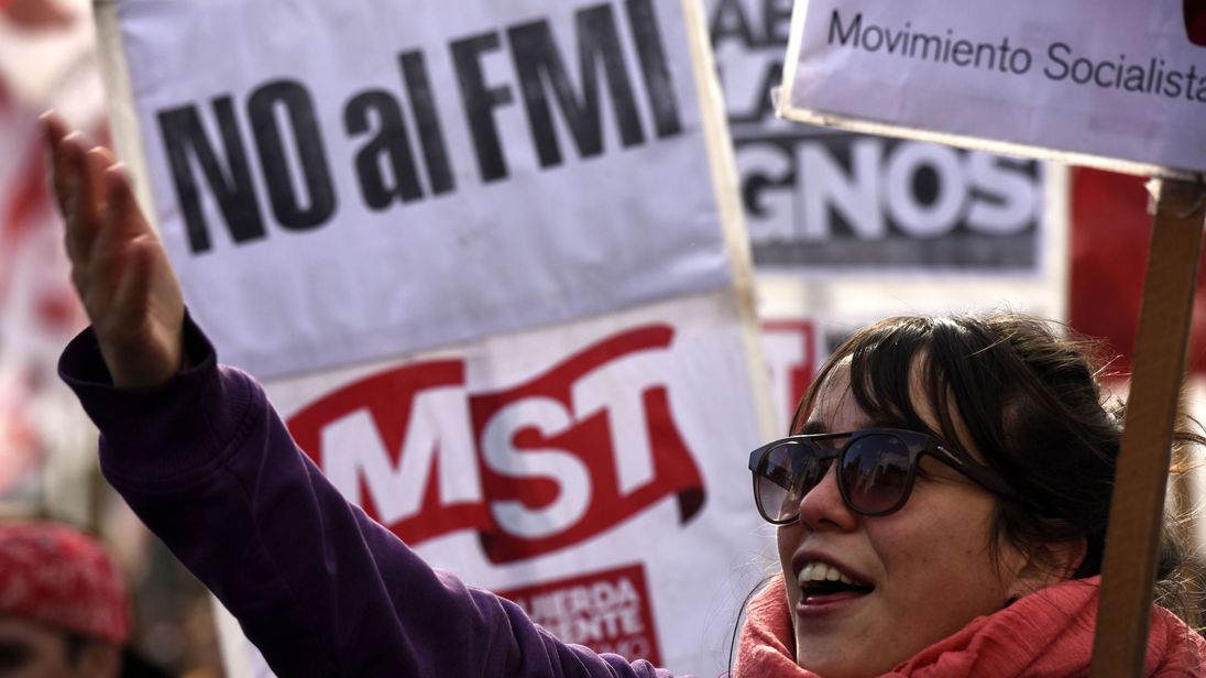 Protest signs reading 'No to the IMF' at a demonstration in Argentina
