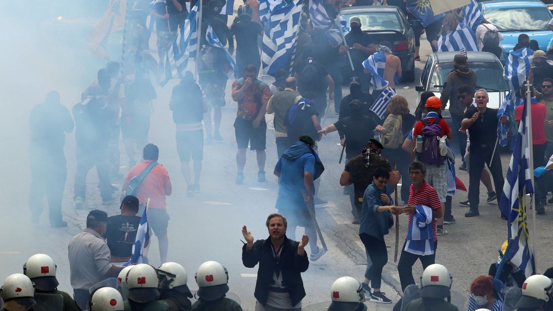 A man faces riot police in Pisoderi near the border with Macedonia 