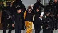 Doan Thi Huong (C) is escorted by Malaysian police from court