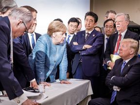 A photo shared on Angela Merkel&#39;s official Instagram account hints at tension among G7 leaders