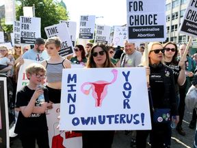 Pro-abortion protestors hold placards during a demonstration calling for abortion to be legalised in Northern Ireland, outside Belfast city hall