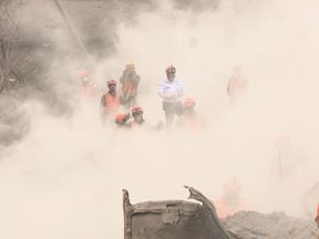 Clouds of dust hang in the air every time a firefighter plants a spade in the ground