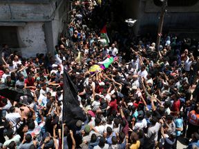 Mourners carry the body of Palestinian nurse Razan Al-Najar