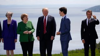 Britain's Prime Minister Theresa May, Germany's Chancellor Angela Merkel, U.S. President Donald Trump, Canada's Prime Minister Justin Trudeau and France's President Emmanuel Macron stand together for a family photo with the other leaders of the G-7 summit in the Charlevoix city of La Malbaie, Quebec, Canada, June 8, 2018. REUTERS/Leah Millis