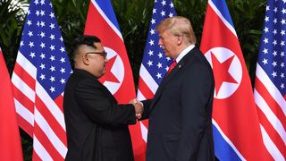North Korea's leader Kim Jong Un (L) shakes hands with US President Donald Trump (R) at the start of their historic US-North Korea summit, at the Capella Hotel on Sentosa island in Singapore on June 12, 2018. - Donald Trump and Kim Jong Un have become on June 12 the first sitting US and North Korean leaders to meet, shake hands and negotiate to end a decades-old nuclear stand-off