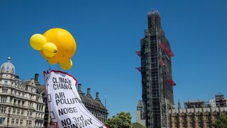 Greenpeace activists fly a banner as they demonstrate against plans to build a third runway at Heathrow