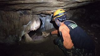 Rescue teams battle high water to find boys missing in Thai cave