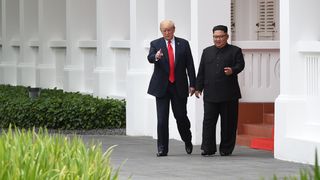 Donald Trump and Kim Jong Un during a break in their talks