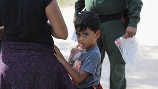 A family waits to be taken into custody