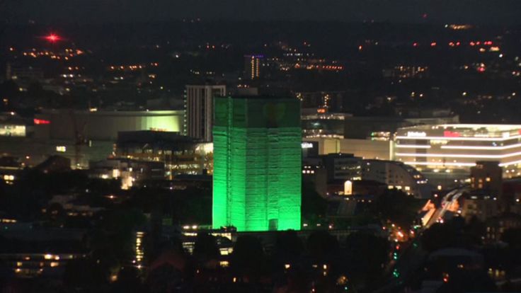 Green lights are illuminating Grenfell Tower