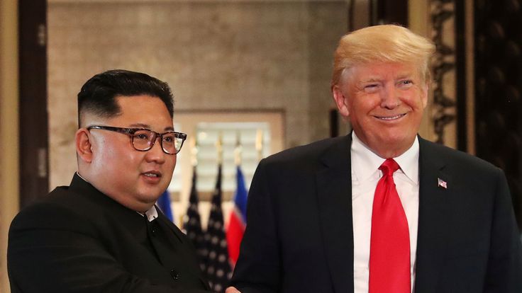 U.S. President Donald Trump and North Korea's leader Kim Jong Un shake hands after signing documents during a summit at the Capella Hotel on the resort island of Sentosa, Singapore June 12, 2018