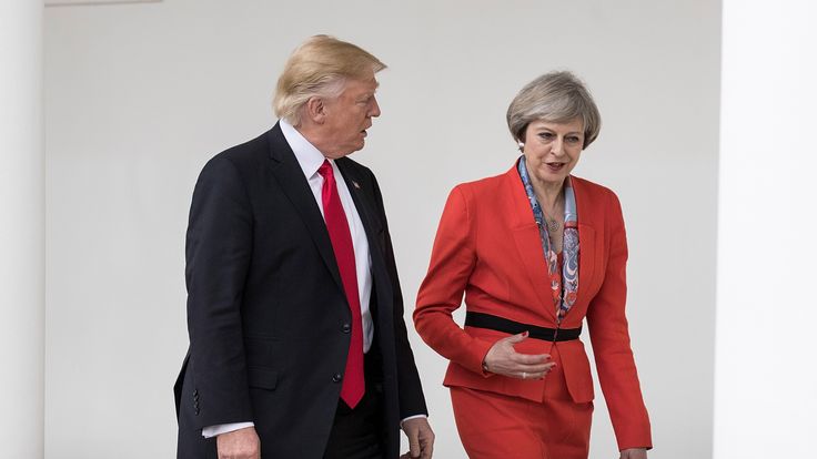 Theresa May and Donald Trump walk along The Colonnade in the White House