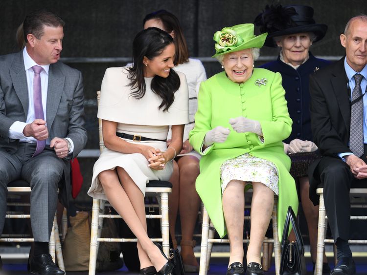 Queen Elizabeth and Meghan sit together at the bridge opening