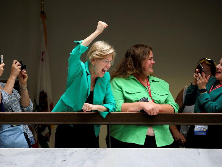U.S. Senator Elizabeth Warren (D-MA) cheers on demonstrators calling for "an end to family detention" and in opposition to the immigration policies of the Trump administration, as they are arrested by U.S. Capitol Police at the Hart Senate Office Building on Capitol Hill in Washington, U.S. June 28, 2018. REUTERS/Jonathan Ernst TPX IMAGES OF THE DAY