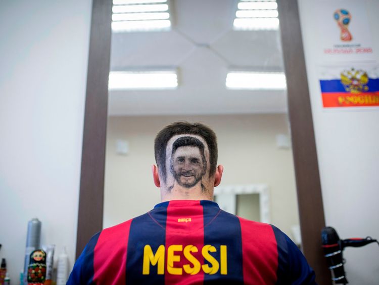 A football fan sports a hair tattoo showing the portrait of Argentinian football player Lionel Messi