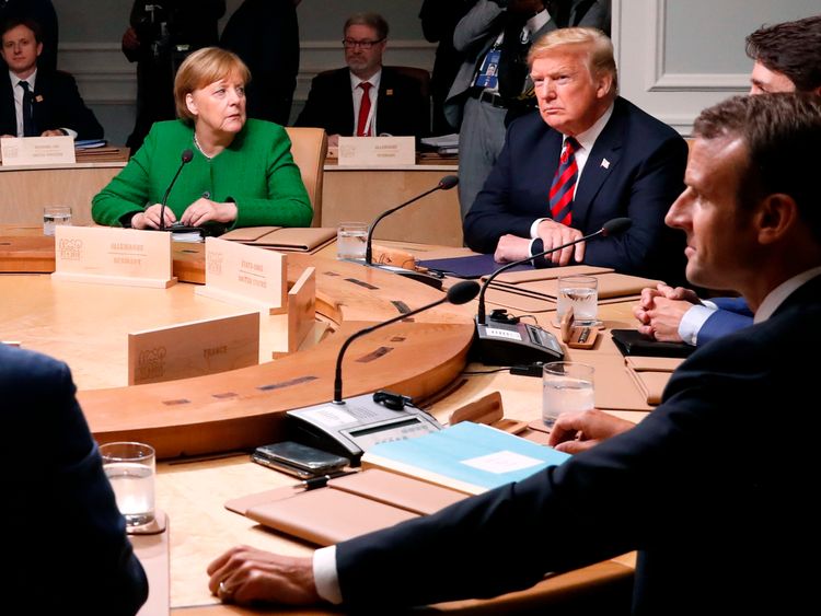 Germany's Chancellor Angela Merkel looks over at U.S. President Donald Trump as they meet with Canada's Prime Minister Justin Trudeau, France's President Emmanuel Macron and the other leaders for a plenary session at the G7 summit in Charlevoix, Quebec, Canada, June 8, 2018. REUTERS/Leah Millis