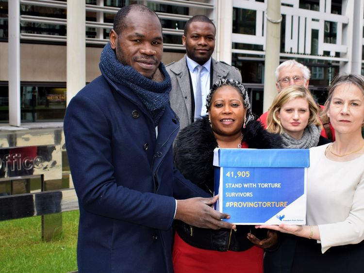 Mr Haoussou hands a petition to former MP Tania Matthias at the home office