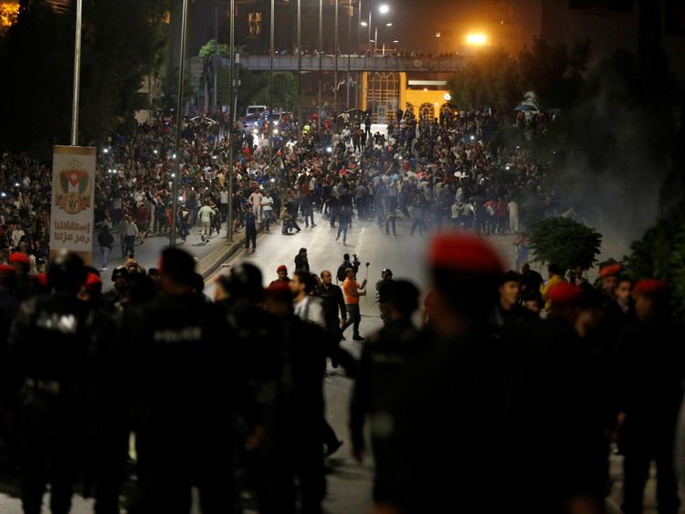 Demonstrators clash with riot police during a protest in Amman