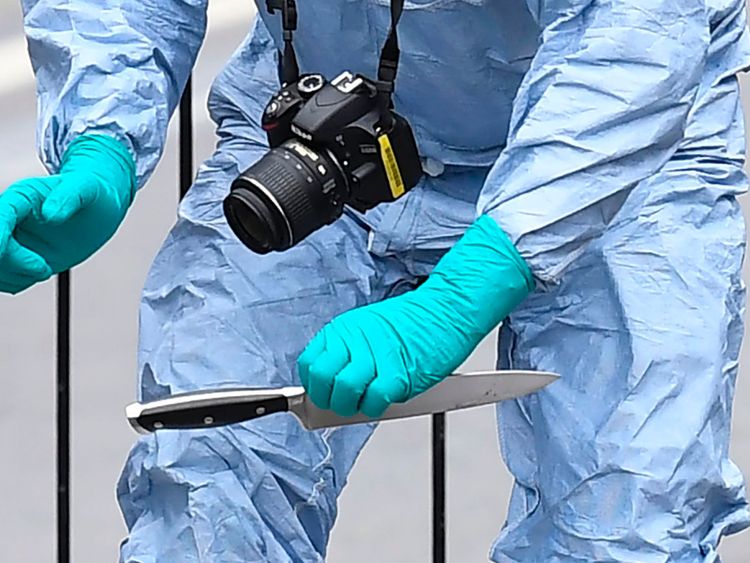 A British police forensics officer holds a knife as evidence is collected on Whitehall near the Houses of Parliament in central London on April 27, 2017, at the scene where a man was detained and taken away by police. Metropolitan police attended an incident on Whitehall in central London near the Houses of Parliament where one man was arrested, police said. Khalid Mohammed Omar Ali, a 27-year-old from north London, is accused of preparing terrorist acts after being arrested not far from PM