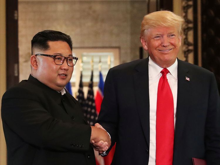 U.S. President Donald Trump and North Korea's leader Kim Jong Un shake hands after signing documents during a summit at the Capella Hotel on the resort island of Sentosa, Singapore June 12, 2018