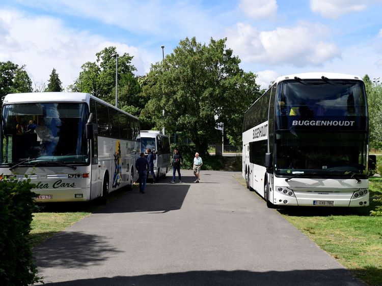 Buses with pupils on a school trip remain in the parking lot of Planckendael Zoo, after a young lioness escaped from its enclosure