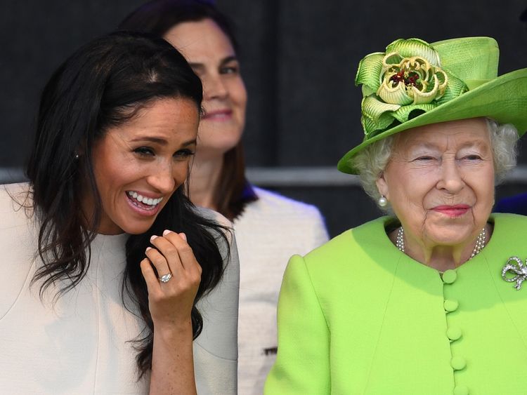 Meghan giggles as she and the Queen sit together