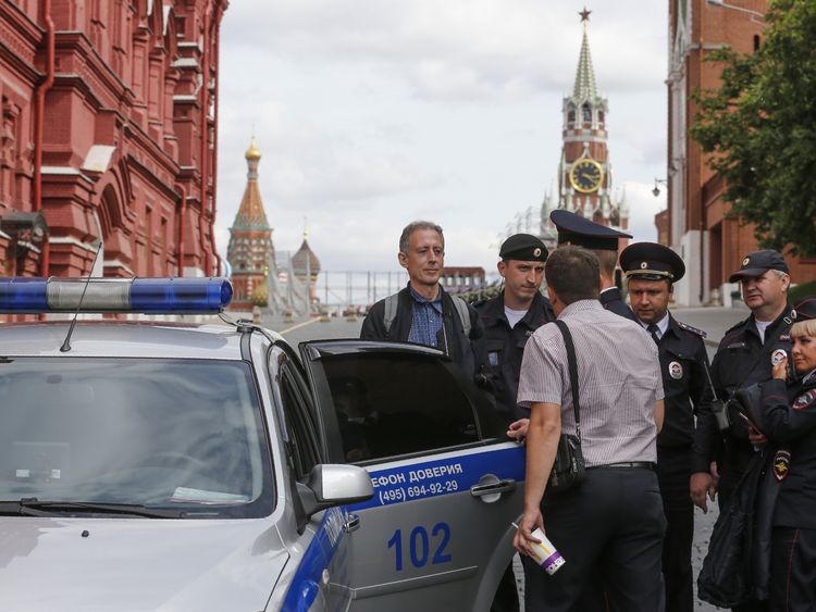 Russian police officers arrest British gay rights activist Peter Tatchell following his anti-Putin protest in Moscow on June 14, 2018. (Photo by Maxim ZMEYEV / AFP) (Photo credit should read MAXIM ZMEYEV/AFP/Getty Images)