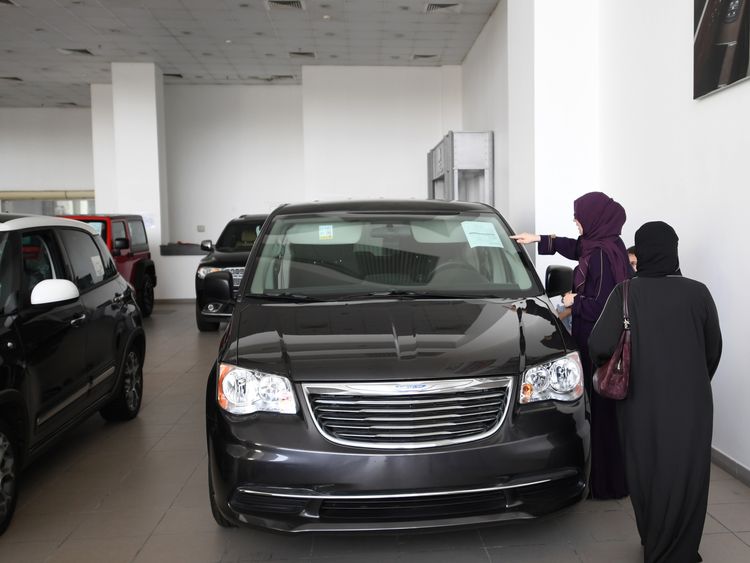 Saudi women examine cars at a showroom in the Red Sea resort of Jeddah on June 23, 2018, a day before the lifting of a ban on women driving in the conservative Arab kingdom