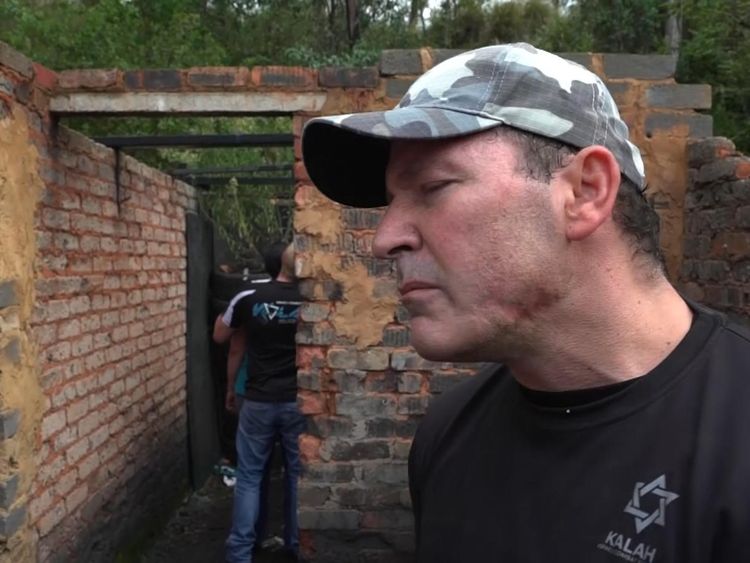 Farmer Chris Herbst shows off a gun wound