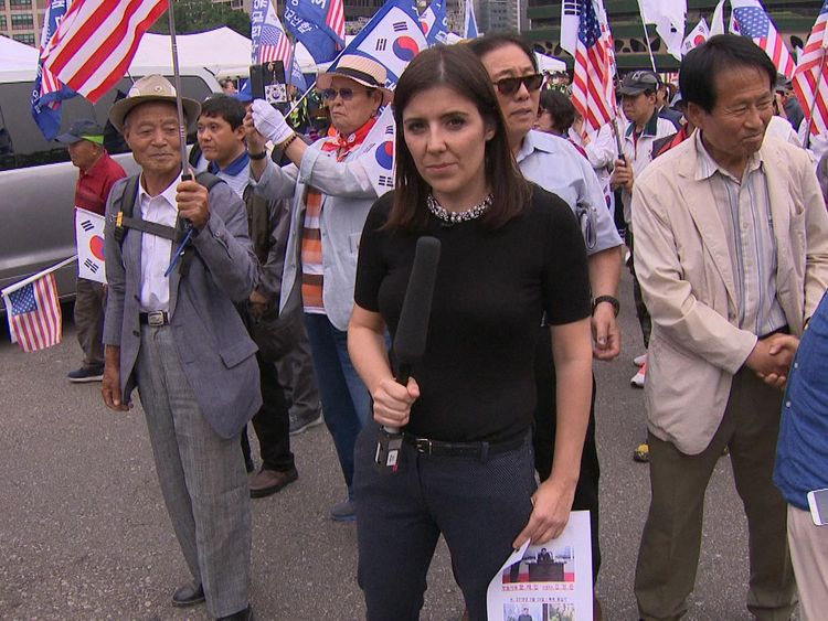 Sky's Siobhan Robbins with protesters in Seoul