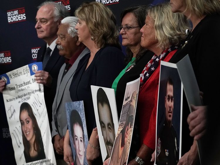 Family members hold portraits of their deceased loved ones that were signed by President Donald Trump during an event with 'Angel Families' June 22, 2018