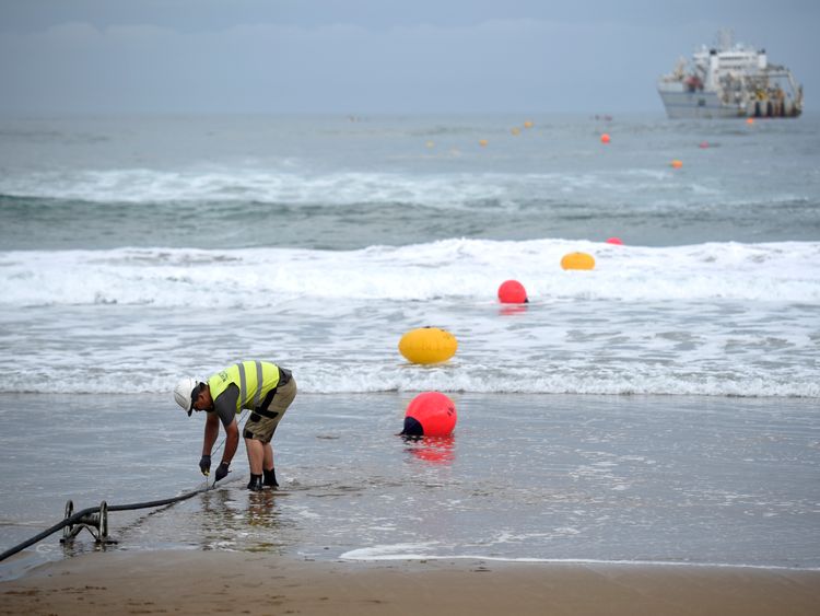An operator works during the mooring of an undersea fiber optic cable at Arrietara beach near the Spanish Basque village of Sopelana on June 13, 2017. Facebook and Microsoft have paired up to run a giant underwater cable dubbed Marea (tide) that will stretch from Virginia in the US to Bilbao, Spain, crossing some 6,600 kilometers of ocean. / AFP PHOTO / ANDER GILLENEA (Photo credit should read ANDER GILLENEA/AFP/Getty Images) 