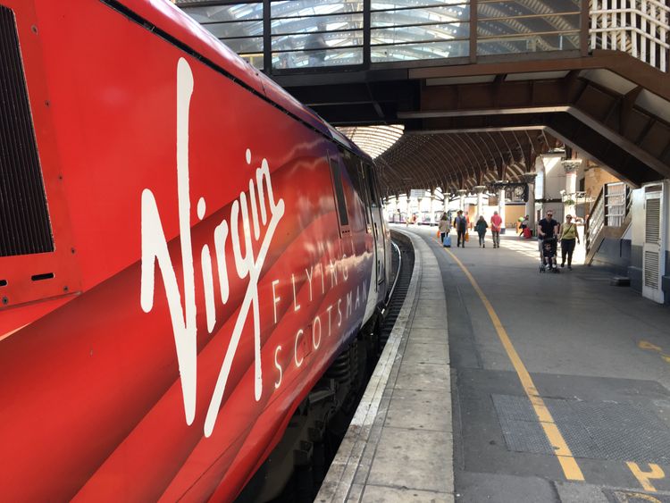 The first LNER Flying Scotsman service from Edinburgh to London arrives with Virgin livery