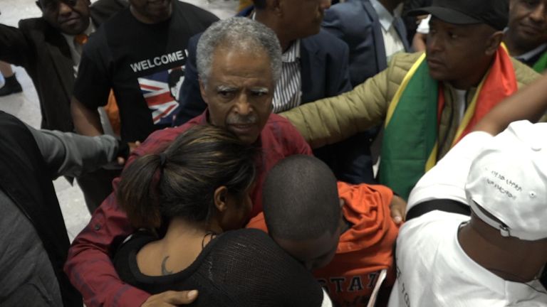 Andy Tsege being greeted at Heathrow Airport