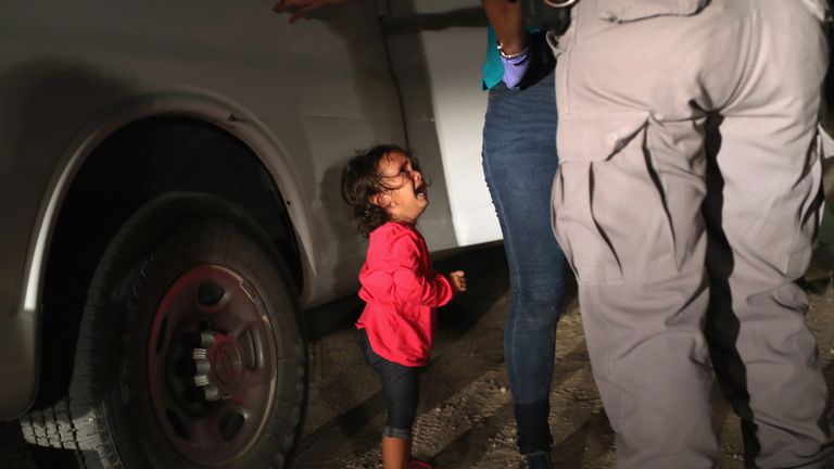 A two-year-old Honduran asylum seeker cries as her mother is detained near the US-Mexico border 
