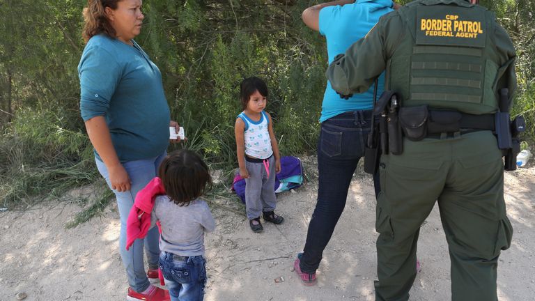 Border Patrol agents take Central American asylum seekers into custody near McAllen, Texas