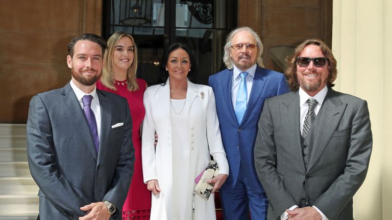 Singer and songwriter Barry Gibb, with his wife, Linda, and children, Michael (left), Alexandra and Ashley (right) at Buckingham Palace