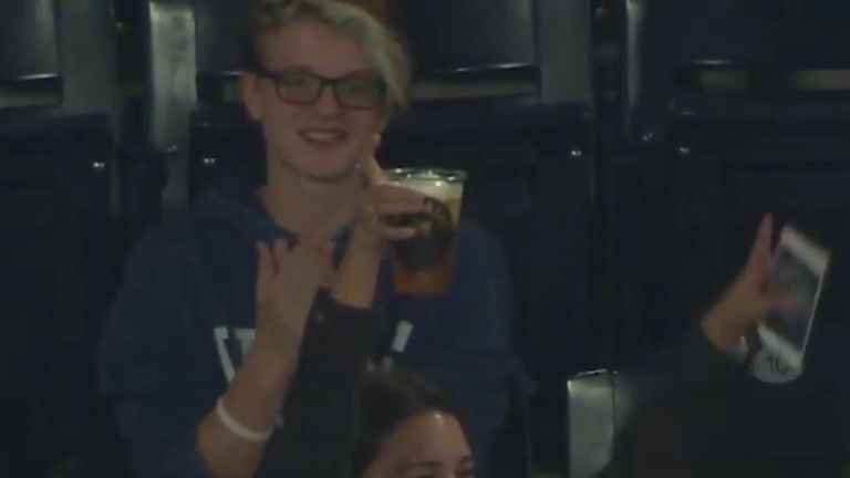Woman catches baseball ball in her beer