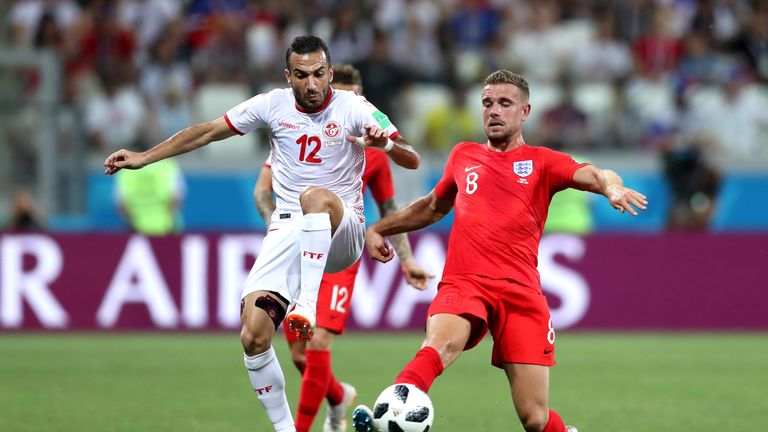 Jordan Henderson and Ali Maaloul battle for possession