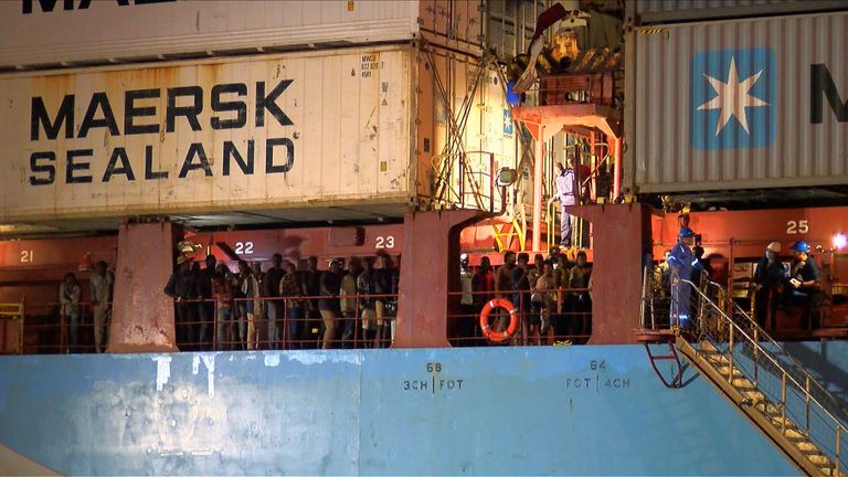 TOPSHOT - In this video grab made on June 26, 2018 from an AFP video, rescued migrants are seen waiting to disembark from the Danish container ship, the Alexander Maersk, at the port of Sicilian port of Pozzallo. - A Danish cargo ship owned by Maersk, the world&#39;s leading container shipping company, with 108 migrants on board was allowed to dock at the southern Sicilian port of Pozzallo Monday, after waiting offshore for three days for instructions from the Italian authorities