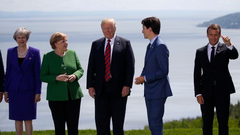 Britain&#39;s Prime Minister Theresa May, Germany&#39;s Chancellor Angela Merkel, U.S. President Donald Trump, Canada&#39;s Prime Minister Justin Trudeau and France&#39;s President Emmanuel Macron stand together for a family photo with the other leaders of the G-7 summit in the Charlevoix city of La Malbaie, Quebec, Canada, June 8, 2018. REUTERS/Leah Millis